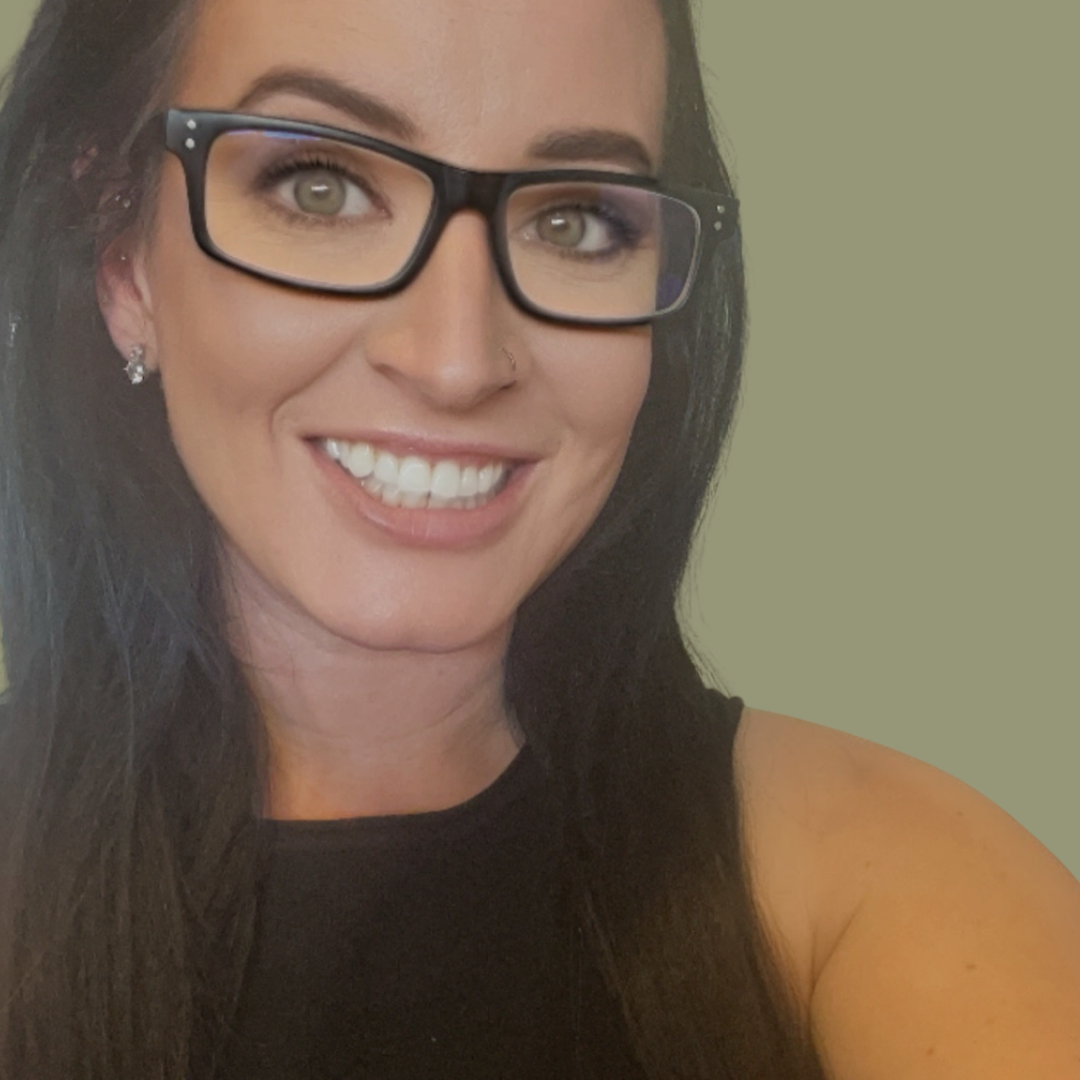 Owner of Pure Indulgence Beauty Therapy, smiling, wearing glasses
